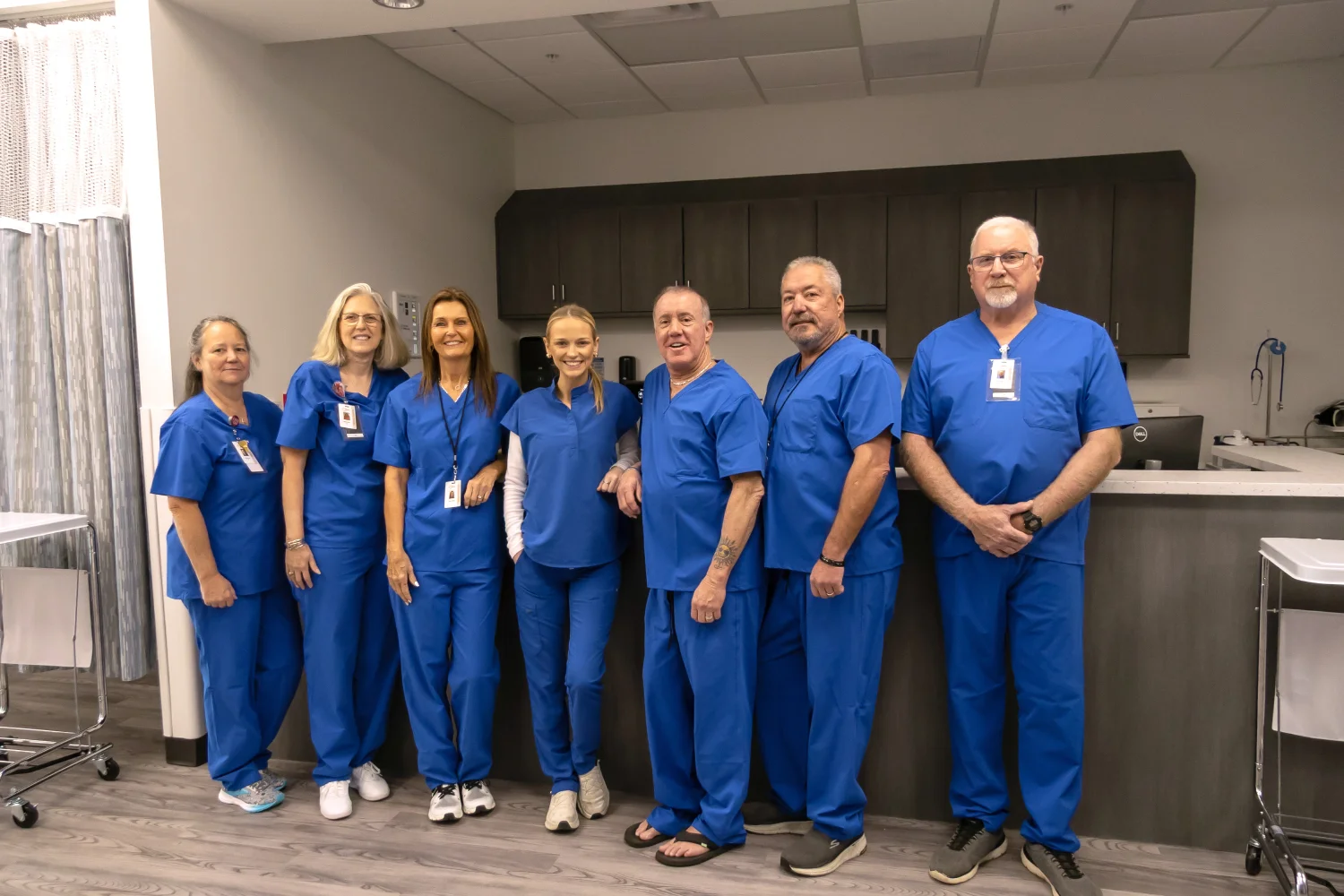 Dr. Jeffrey Tauth and his care team in blue scrubs